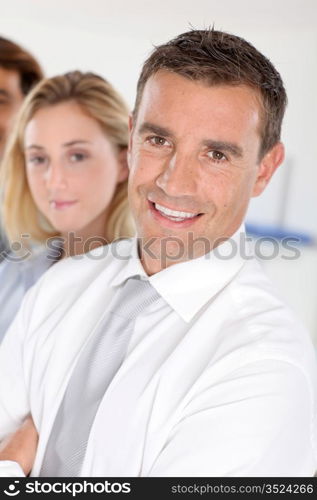 Portrait of businessman standing in front of group