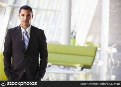 Portrait Of Businessman Standing Modern Office Reception