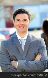 Portrait of businessman standing outside the office