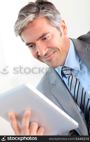 Portrait of businessman using electronic tablet