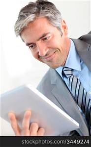 Portrait of businessman using electronic tablet