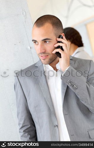 Portrait of businessman using mobile phone