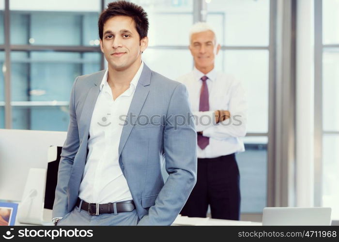 Portrait of businessman with collegue on background. Member of team