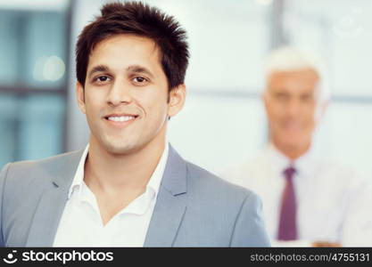 Portrait of businessman with collegue on background. Member of team