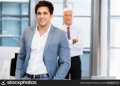 Portrait of businessman with collegue on background. Member of team