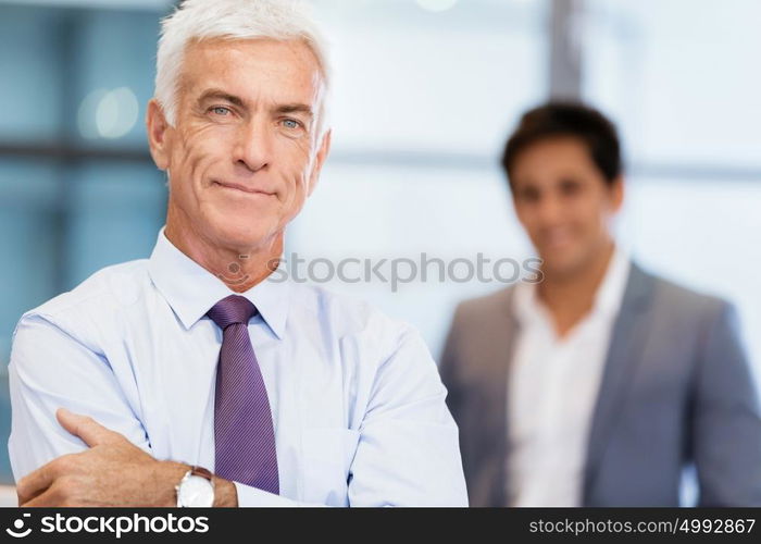 Portrait of businessman with collegue on background. Member of team