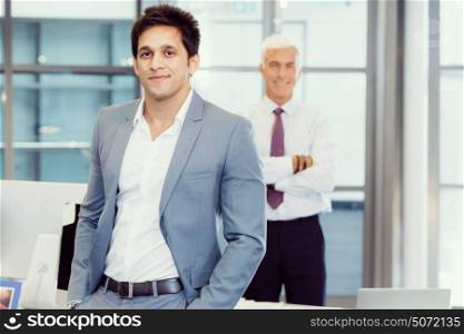 Portrait of businessman with collegue on background. Member of team