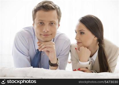 Portrait of businessman with coworker in hotel