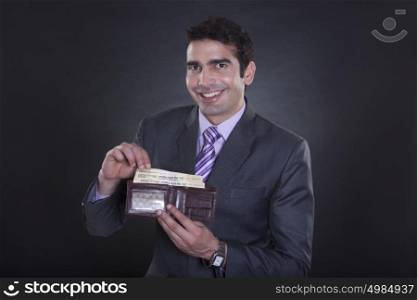 Portrait of businessman with currency in wallet