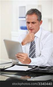 Portrait of businessman with electronic tab