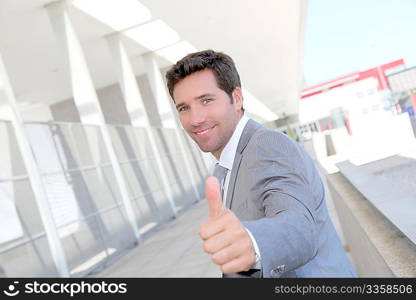 Portrait of businessman with thumb up