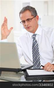 Portrait of businessman working on laptop computer