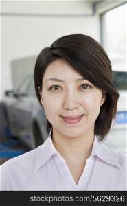 Portrait of Businesswoman at Car Repair Garage