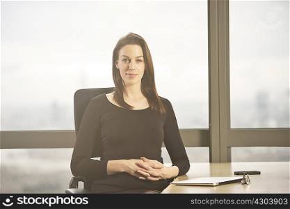 Portrait of businesswoman at office desk