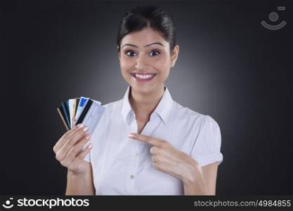 Portrait of businesswoman holding credit cards