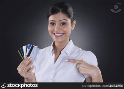 Portrait of businesswoman holding credit cards