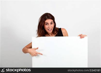 Portrait of businesswoman holding whiteboard