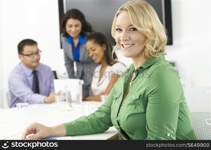 Portrait Of Businesswoman In Boardroom With Colleagues