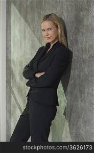 Portrait of businesswoman leaning on wall