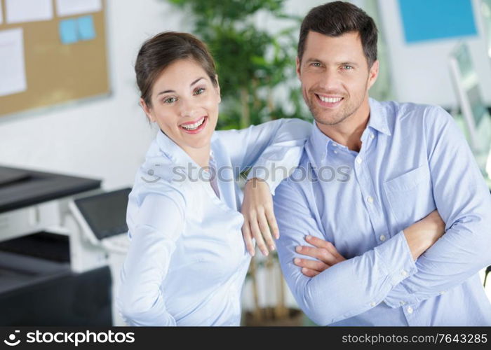 portrait of businesswoman looking at confident colleague in office