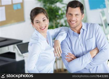 portrait of businesswoman looking at confident colleague in office