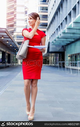 Portrait of businesswoman outside. Portrait of beautiful business woman in red dress