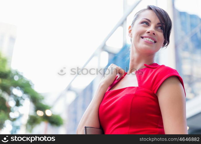 Portrait of businesswoman outside. Portrait of beautiful business woman in red dress