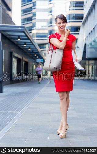 Portrait of businesswoman outside. Portrait of beautiful business woman in red dress