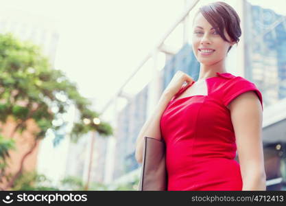 Portrait of businesswoman outside. Portrait of beautiful business woman in red dress