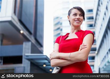 Portrait of businesswoman outside. Portrait of beautiful business woman in red dress