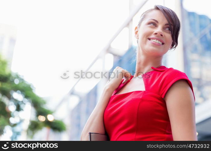 Portrait of businesswoman outside. Portrait of beautiful business woman in red dress