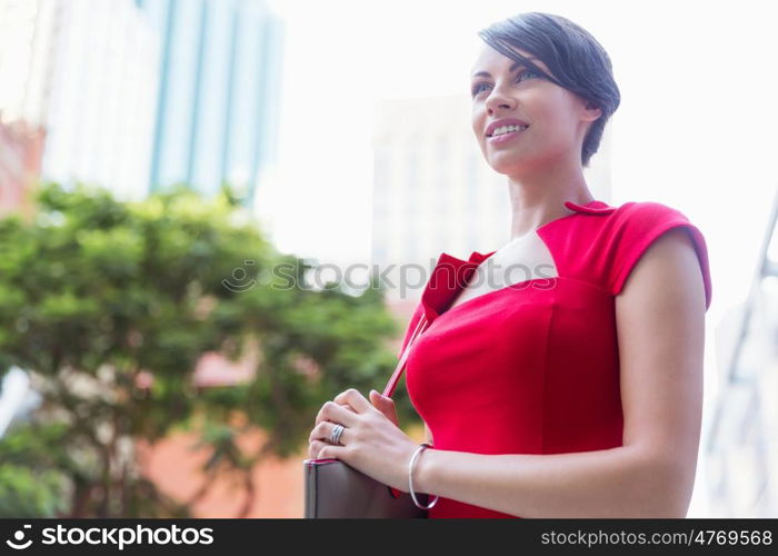 Portrait of businesswoman outside. Portrait of beautiful business woman in red dress