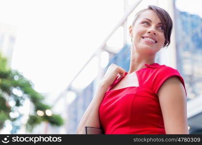 Portrait of businesswoman outside. Portrait of beautiful business woman in red dress