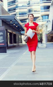 Portrait of businesswoman outside. Portrait of beautiful business woman in red dress