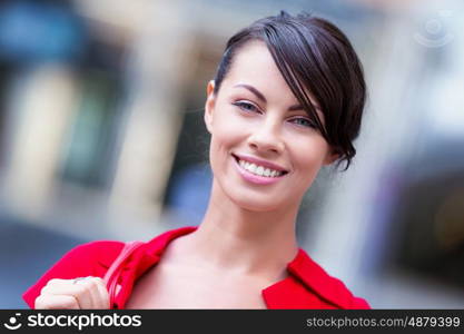 Portrait of businesswoman outside. Portrait of beautiful business woman in red dress