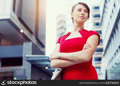 Portrait of businesswoman outside. Portrait of beautiful business woman in red dress