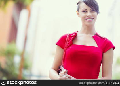 Portrait of businesswoman outside. Portrait of beautiful business woman in red dress