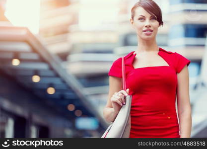 Portrait of businesswoman outside. Portrait of beautiful business woman in red dress