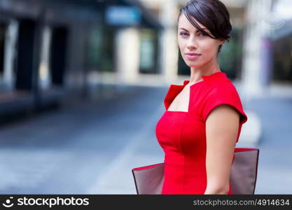 Portrait of businesswoman outside. Portrait of beautiful business woman in red dress