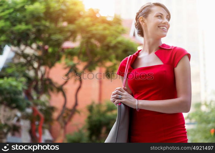 Portrait of businesswoman outside. Portrait of beautiful business woman in red dress