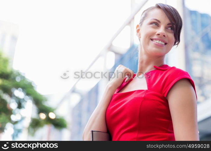 Portrait of businesswoman outside. Portrait of beautiful business woman in red dress