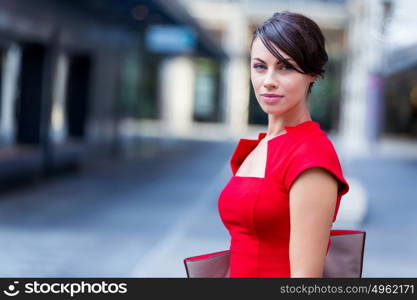 Portrait of businesswoman outside. Portrait of beautiful business woman in red dress