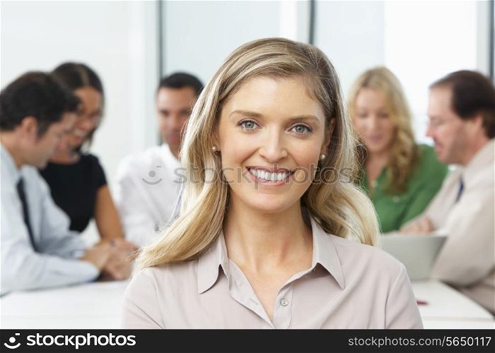 Portrait Of Businesswoman Sitting At Boardroom Table