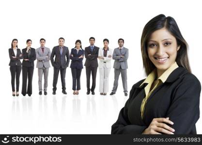 Portrait of businesswoman smiling with businesspeople in background