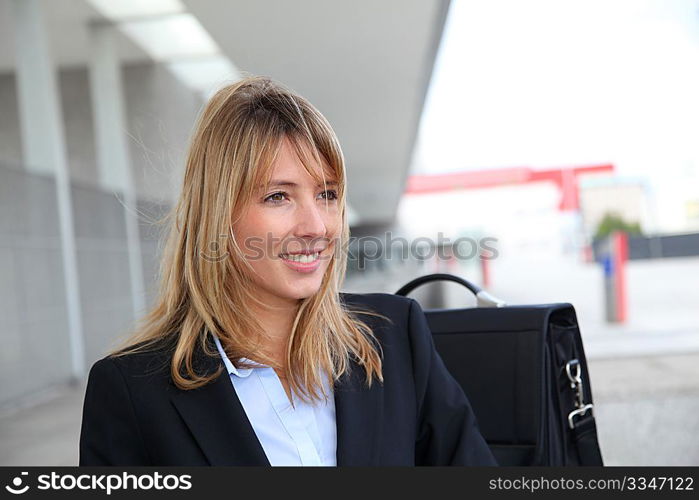 Portrait of businesswoman waiting outside a building