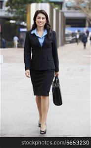 Portrait Of Businesswoman Walking Along Street
