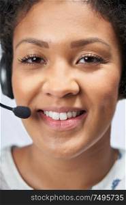 Portrait Of Businesswoman Wearing Telephone Headset In Customer Services Department