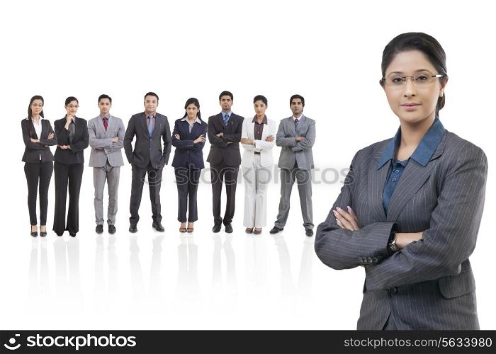 Portrait of businesswoman with businesspeople standing in background