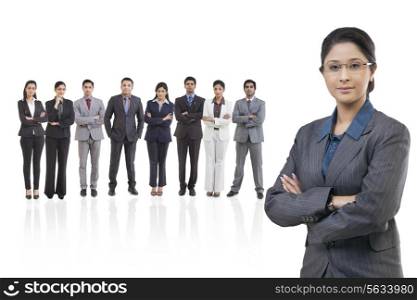 Portrait of businesswoman with businesspeople standing in background