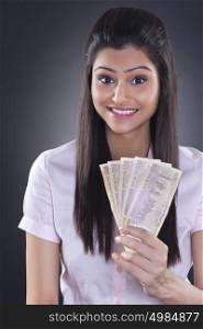 Portrait of businesswoman with currency